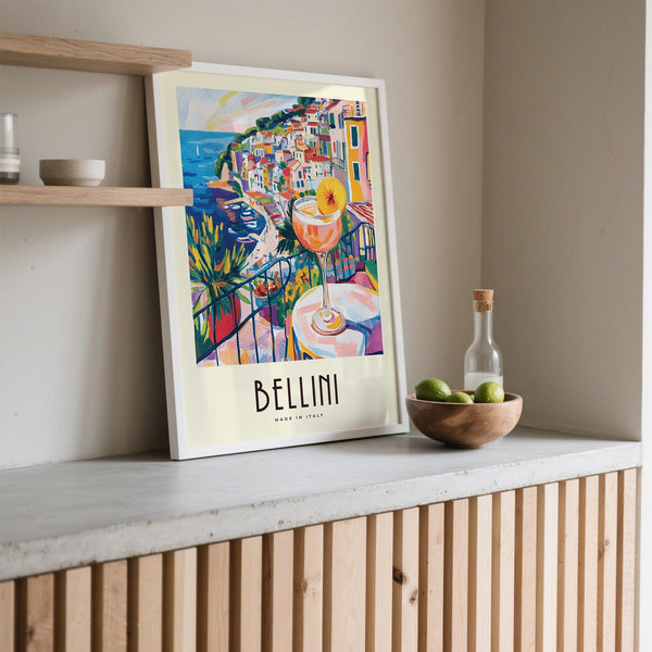 Bright Bellini glass in foreground of Italian Style Cocktail Wall Art coastal setting.