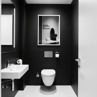Bold Funny Toilet Wall Art beside a stack of white towels.
