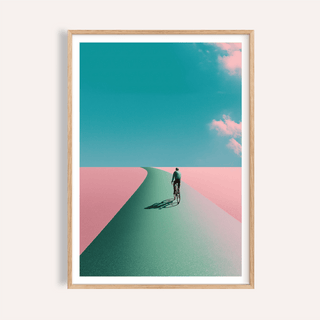 Framed mockup of Surreal Cycling Art Print poster with lone cyclist on a curved road under clouds