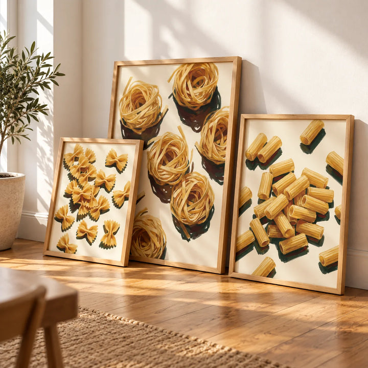 Fettuccine, farfalle and rigatoni prints in three different-sized oak frames beside a sunlit wall. Styling inspiration; frames not included.