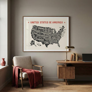 Framed map of the United States on a wall above a chair and desk.