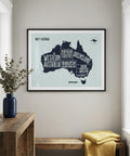 Framed map of Australia on a wall with a wooden console table and bench below.