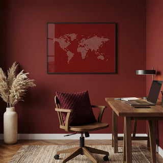 Modern home office with wooden desk, chair, and world map art on red wall.
