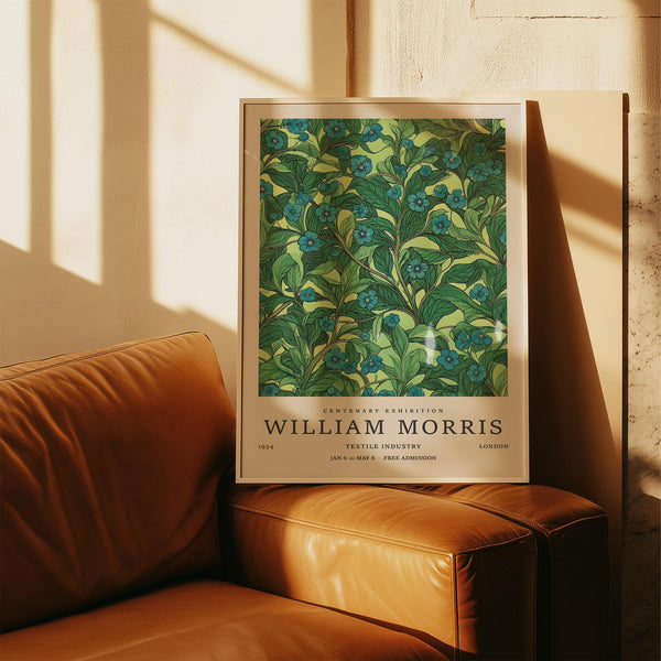 Green floral wall art with blue flowers and leafy vines on a light green background.