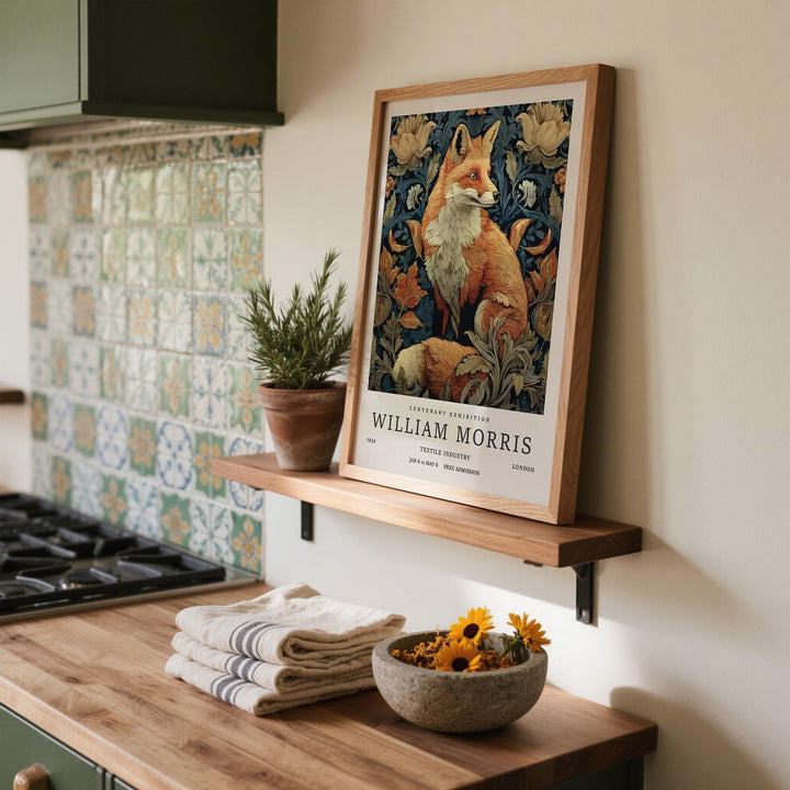 Print leaning on a shelf showing William Morris Fox Print with a red fox and botanical vintage style with a plant pot nearby