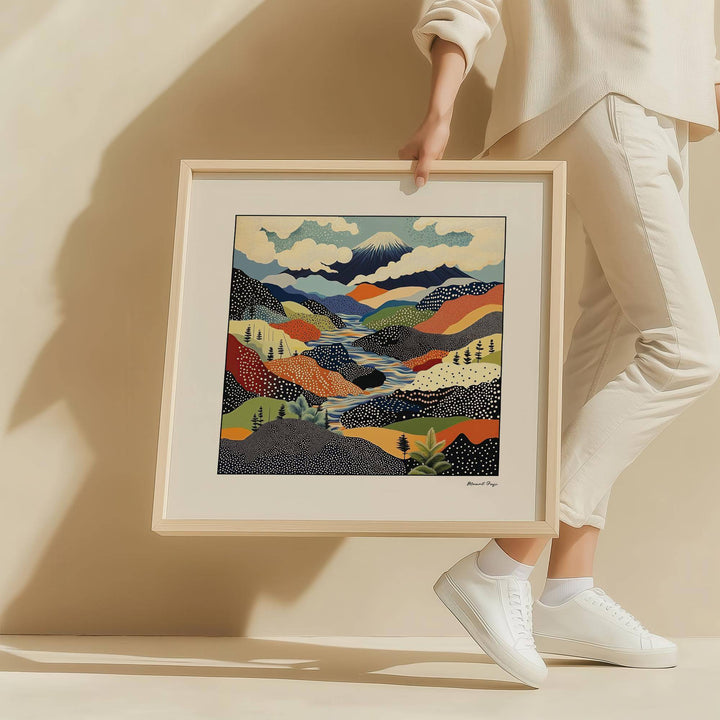 Framed Japanese Art Prints showing an abstract mountain landscape in mid-century style held by a person in white