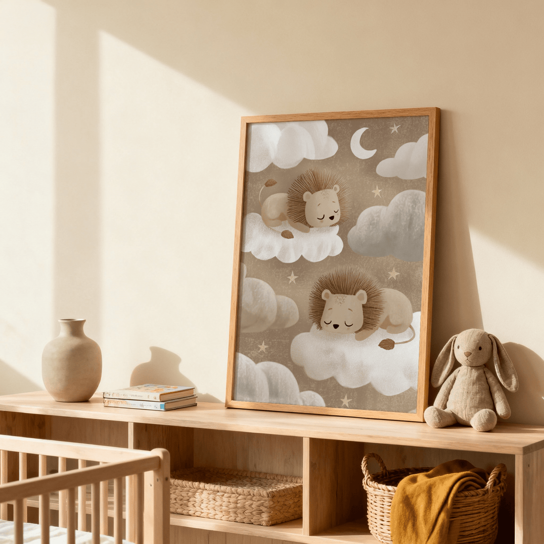 Nursery print of two lion cubs asleep on clouds in a light oak frame, resting on a low wooden shelf beside a cot with a soft bunny toy and woven baskets