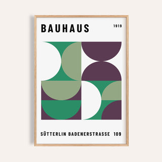 Mid Century Modern Art framed print with green and purple geometric shapes on a beige wall