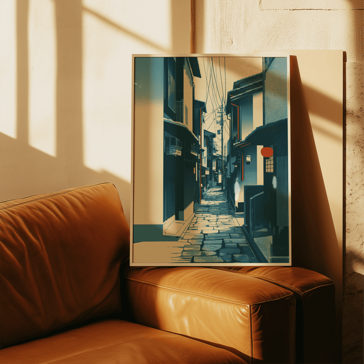 Japanese Street wall art in a frame leaning on a brown leather sofa with sunlight shadows