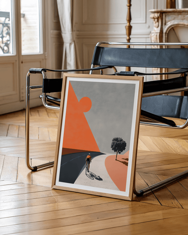 Minimalist cycling wall art print showing lone rider, sweeping roadway, and a single tree