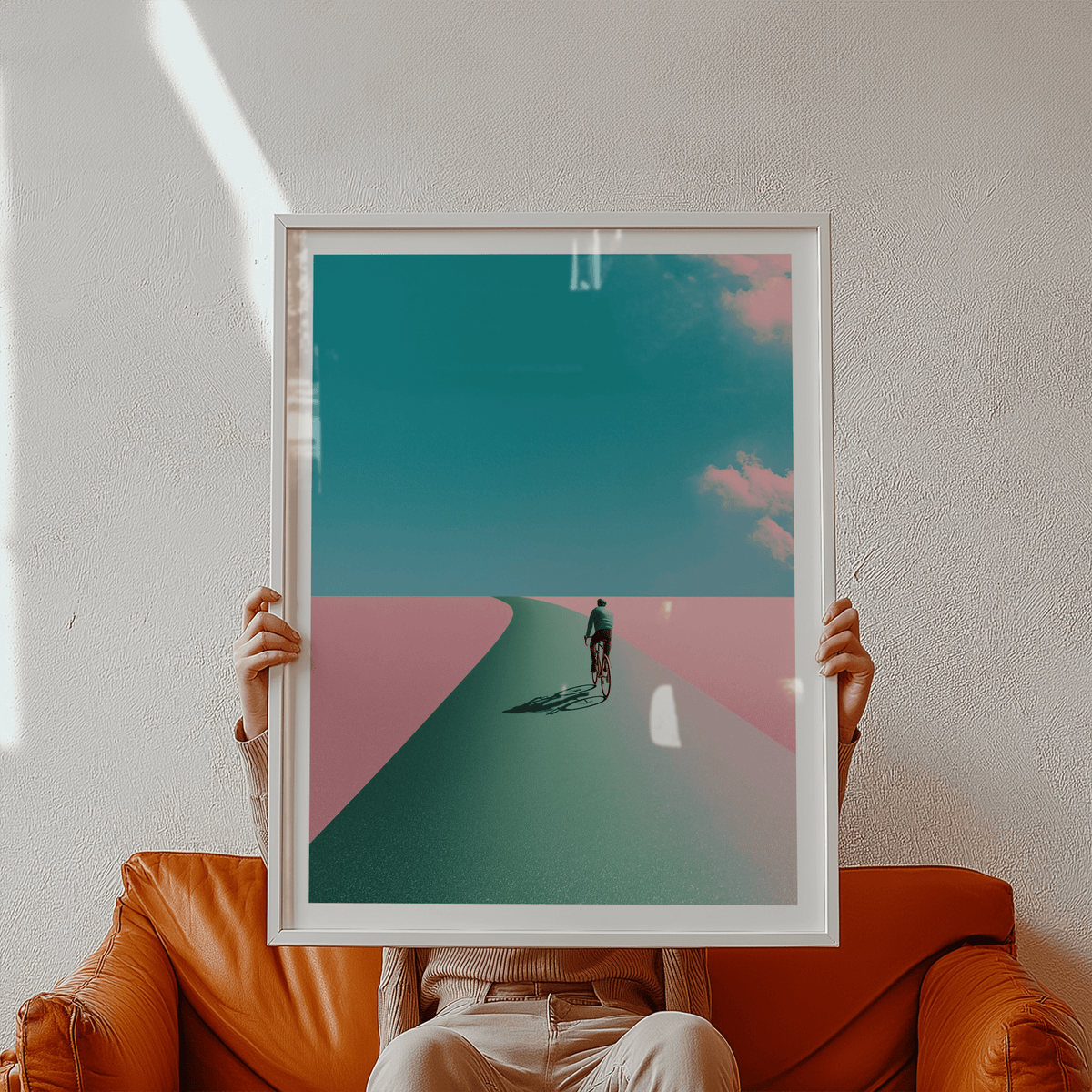 Minimal wall art print depicting a single cyclist riding toward the horizon with wide sky and clouds