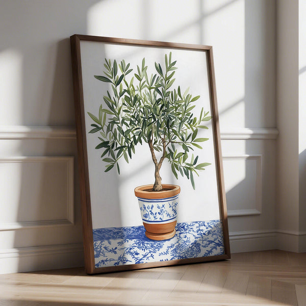 Olive Tree Art print of a green tree in terracotta pot with blue floral pattern on a patterned cloth.