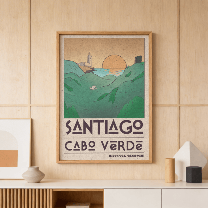 Framed Santiago Cabo Verde art print of coastal hills and sunset in muted green and orange tones on a wooden wall