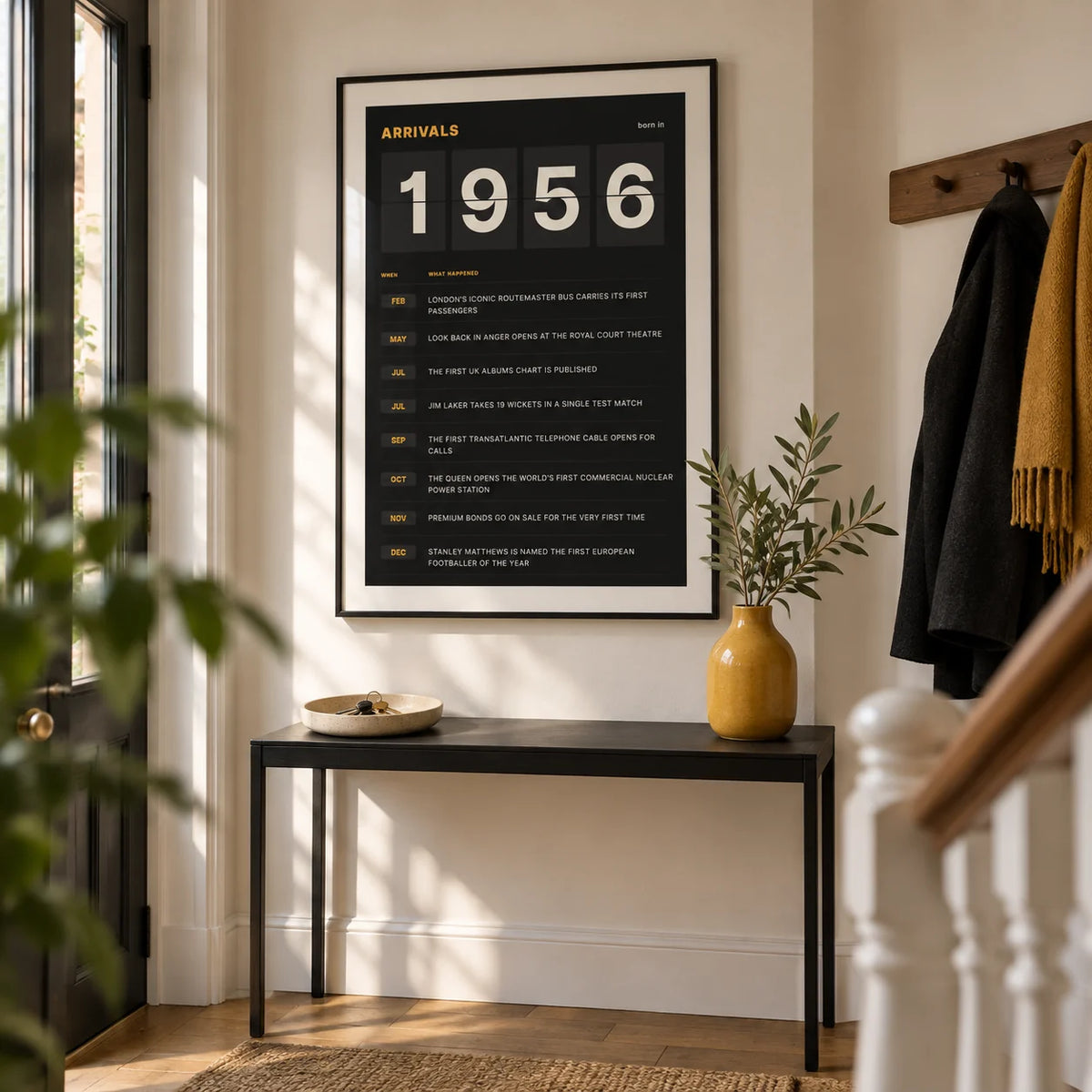 1956 Arrivals Board Print, framed on the wall of a crisp entrance hall in a renovated UK terrace with warm white walls and oak floorboards