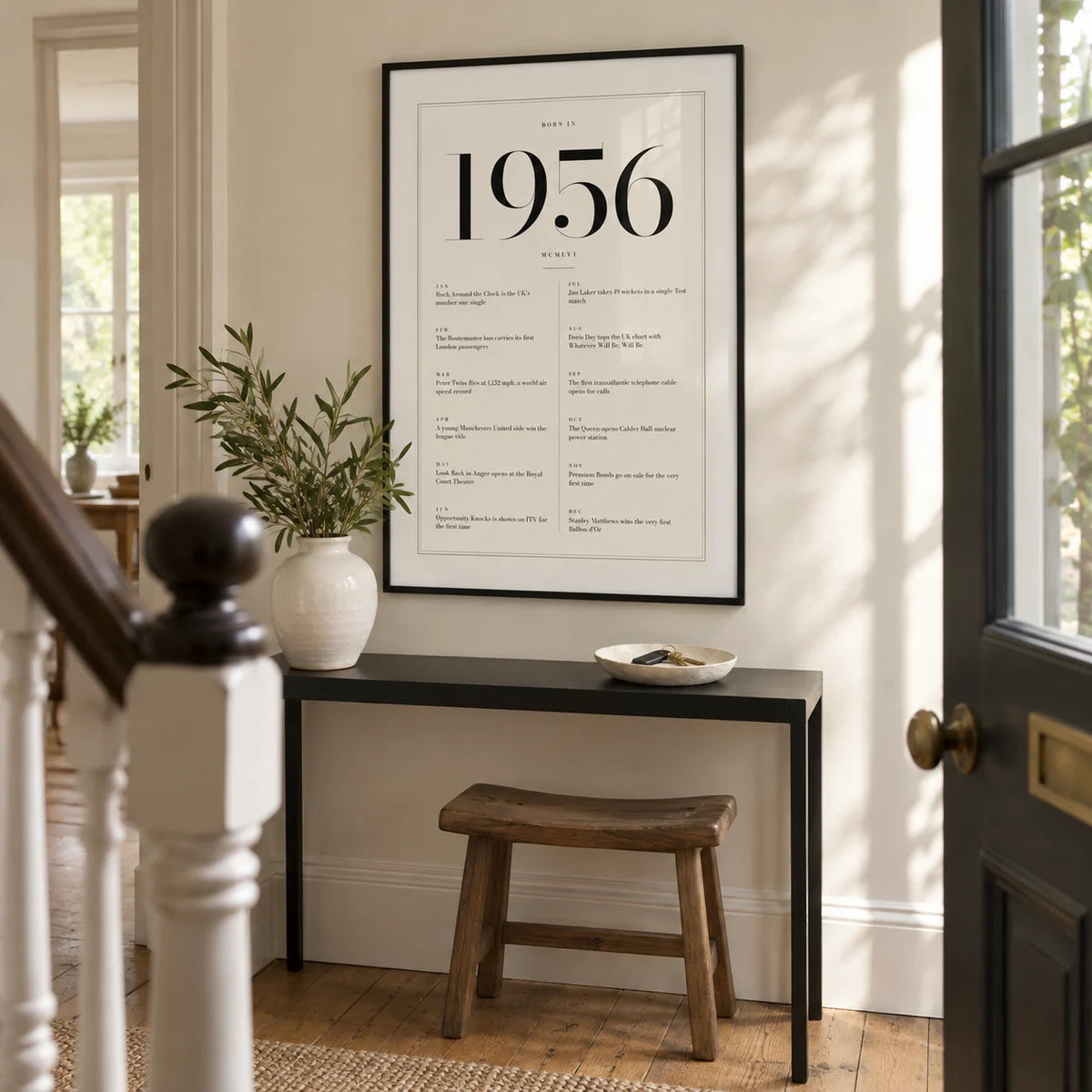 1956 Birthday Print, framed on the wall of a bright entrance hallway in a renovated UK terrace with an ivory wall and original timber floorboards