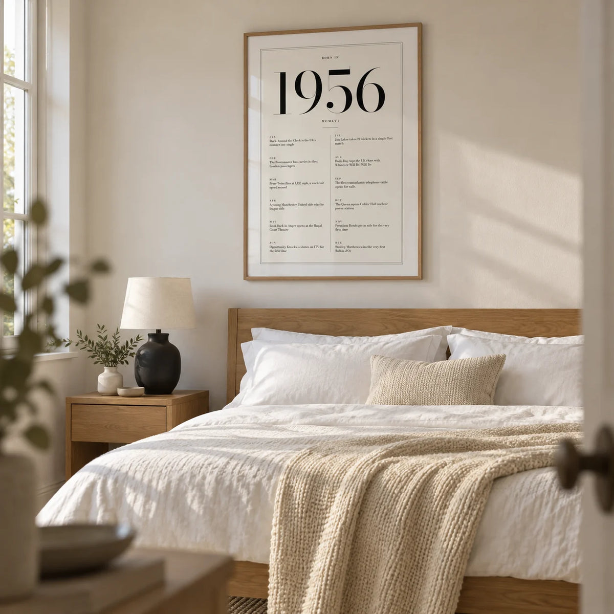 1956 Birthday Print, framed on the wall of a calm contemporary main bedroom in a UK home with an ivory wall and pale oak floor