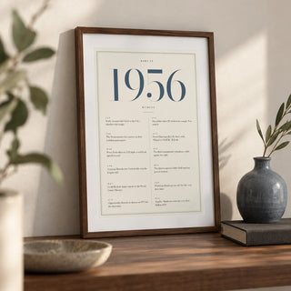 1956 Blue Birthday Print, a small A4 framed print leaning on a walnut shelf in a living room
