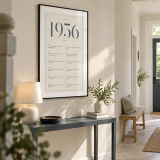 1956 Blue Birthday Print, framed on the wall of a welcoming hallway in a renovated UK semi-detached home with an ivory wall and pale stone floor