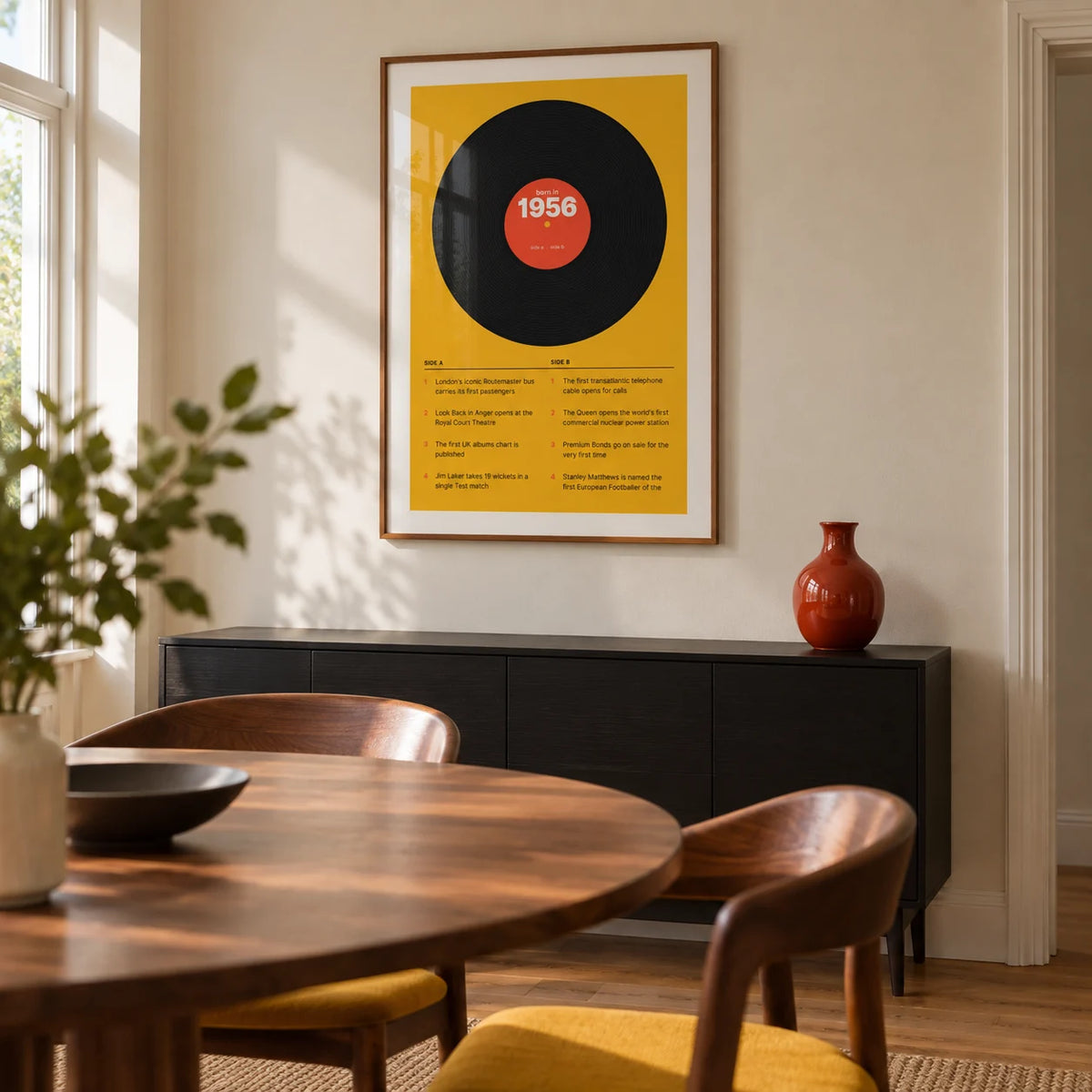 1956 Vinyl Record Print, framed on the wall of a compact modern dining room in a UK semi-detached home with a cream wall and oak floor