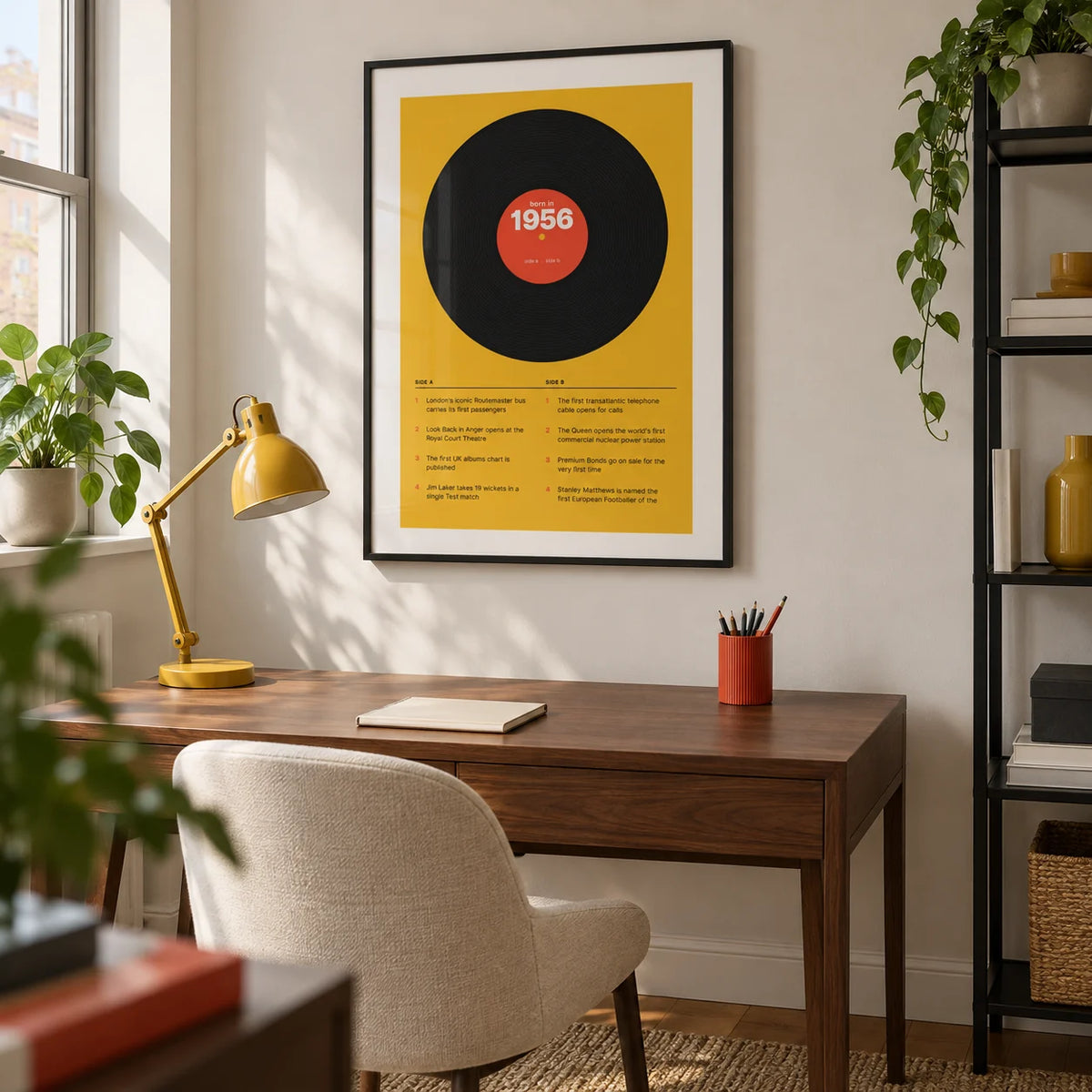 1956 Vinyl Record Print, framed on the wall of a crisp home study in a British city flat with an off-white wall and a black metal shelving unit