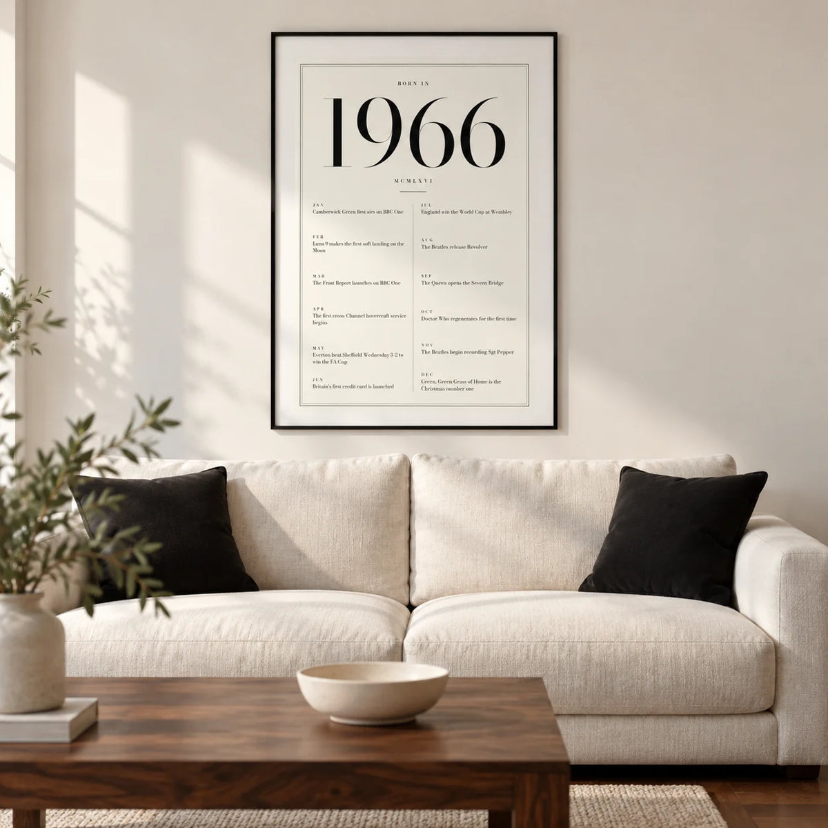 1966 Birthday Print, framed on the wall of a refined modern living room in a UK semi-detached home with a warm white wall and walnut flooring