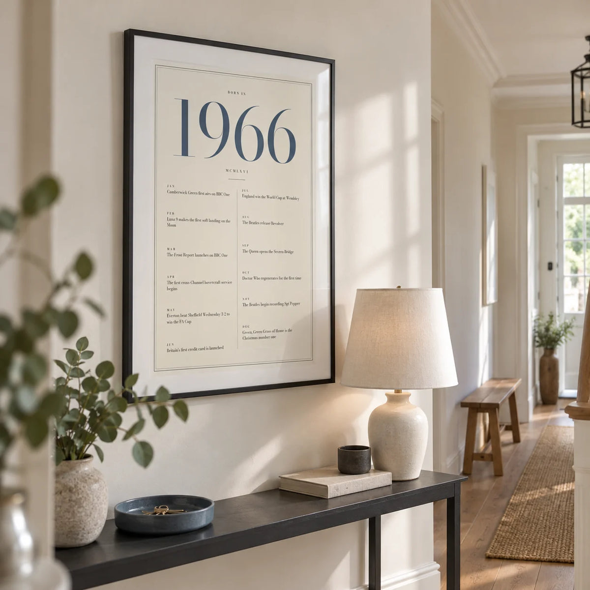 1966 Blue Birthday Print, framed on the wall of a bright entrance hallway in a renovated British townhouse with warm white walls and an oak floor