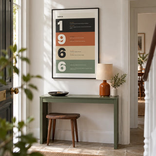 1966 Typography Print, framed on the wall of a bright entrance hallway in a renovated UK terrace with a crisp white wall and plain stone floor
