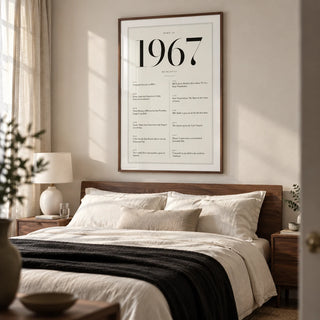 1967 Birthday Print, framed on the wall of a restful grown-up bedroom in a British terrace with a warm white wall and walnut bedside furniture