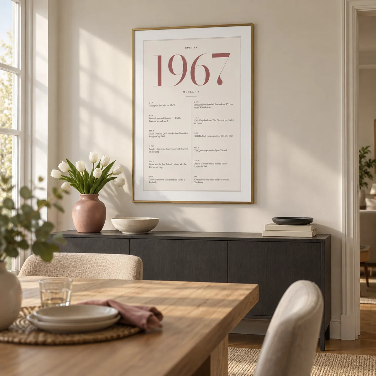 1967 Pink Birthday Print, framed on the wall of a modern dining room in a settled UK family home with a pale ivory wall