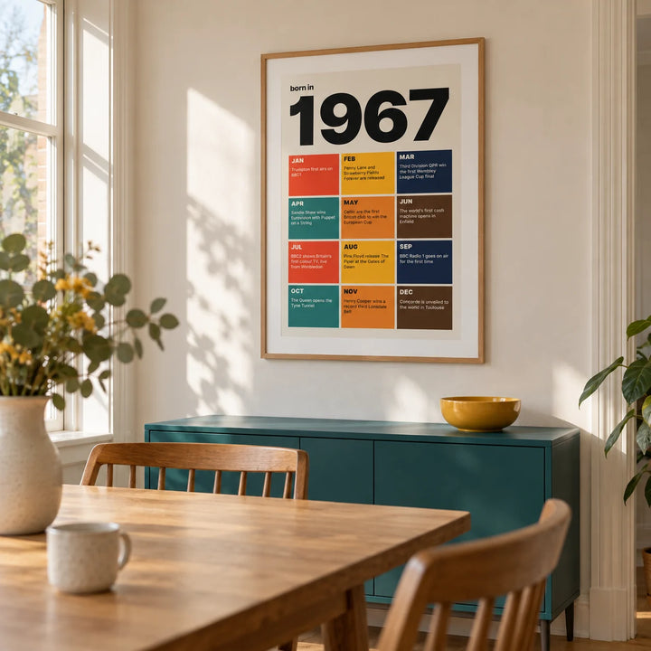 1967 Year in Review Print, framed on the wall of a bright dining room in a UK townhouse with warm white walls and a simple mid-century oak dining table