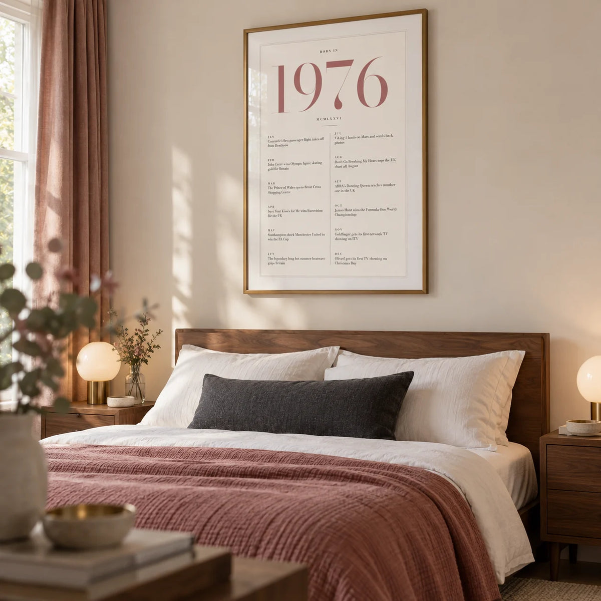 1976 Pink Birthday Print, framed on the wall of a polished main bedroom for a couple around 50 in a UK home with an ivory wall and plain walnut bedside tables