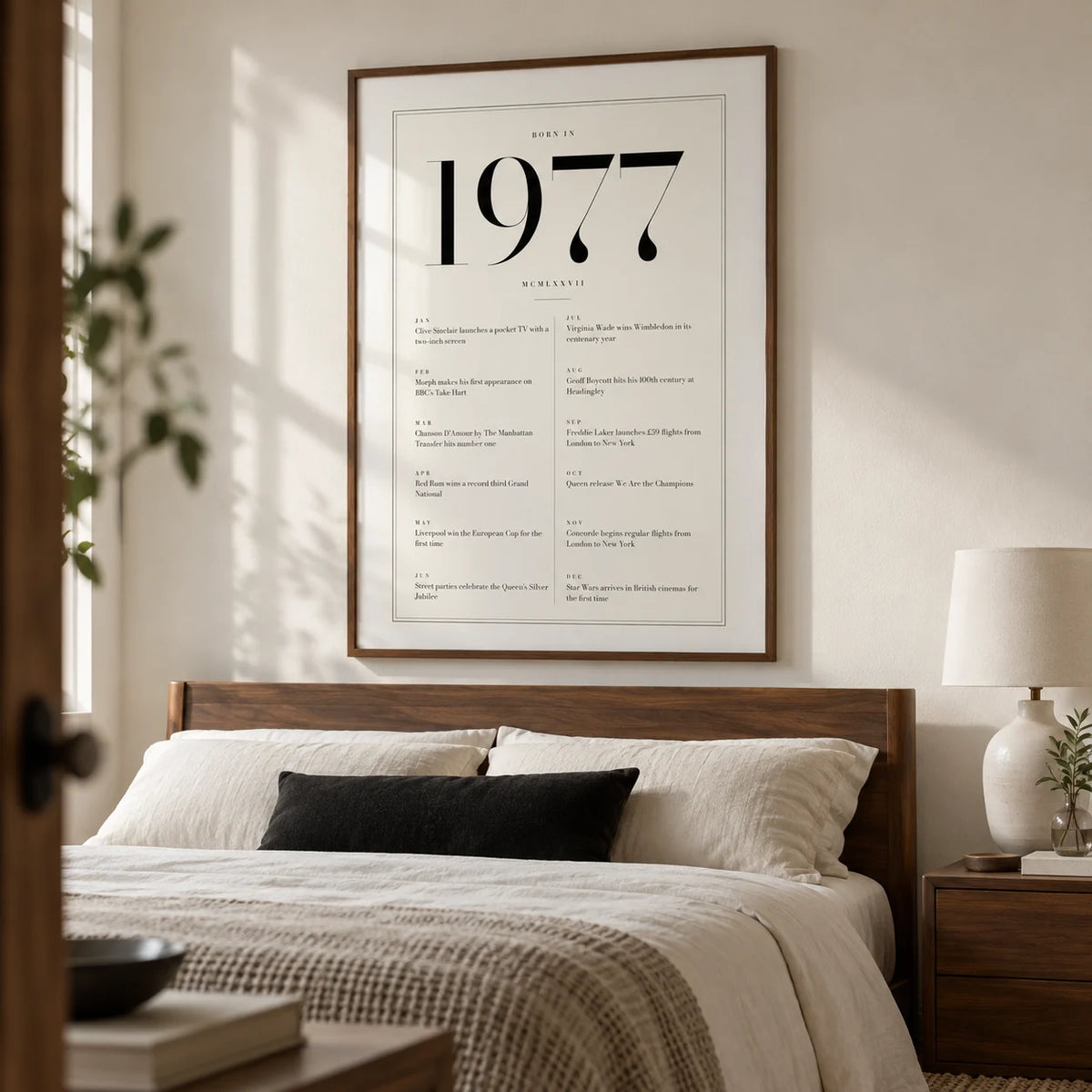 1977 Birthday Print, framed on the wall of a tailored adult bedroom with a soft white wall and walnut furniture
