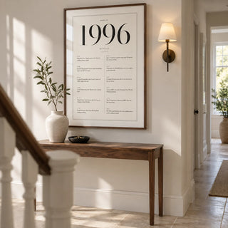 1996 Birthday Print, framed on the wall of a bright hallway in a renovated UK terraced house with warm white walls and pale stone flooring