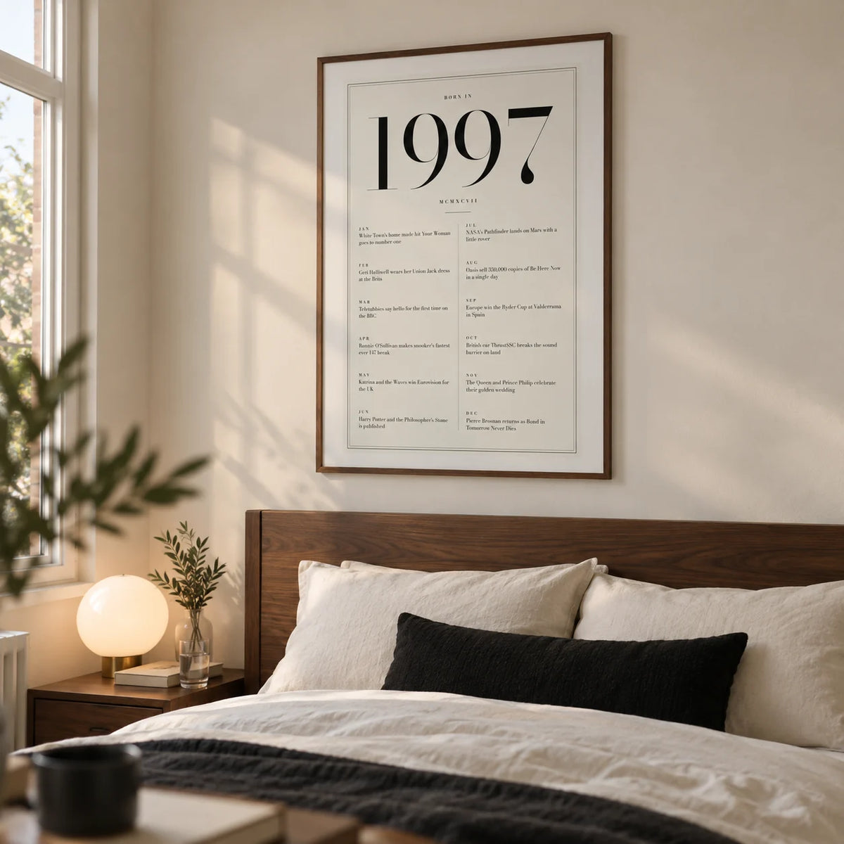 1997 Birthday Print, framed on the wall of a refined bedroom for an adult around 29 in a UK home with a warm white wall