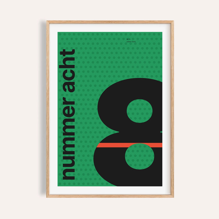 Giant black number 8 on green print shown on a plain warm wall