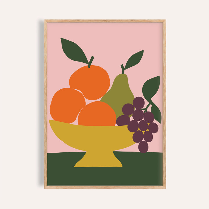 Fruit bowl print with oranges and grapes shown on a plain warm wall