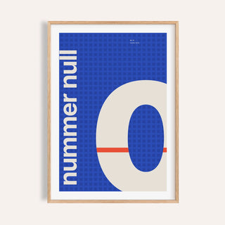 Giant cream number 0 on cobalt print shown on a plain warm wall