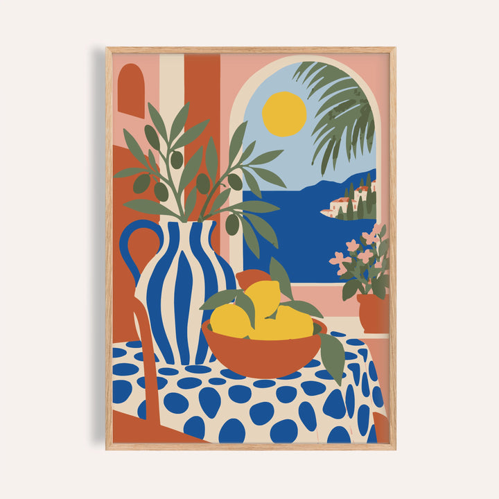 Italian coast print with a table of lemons shown on a plain warm wall