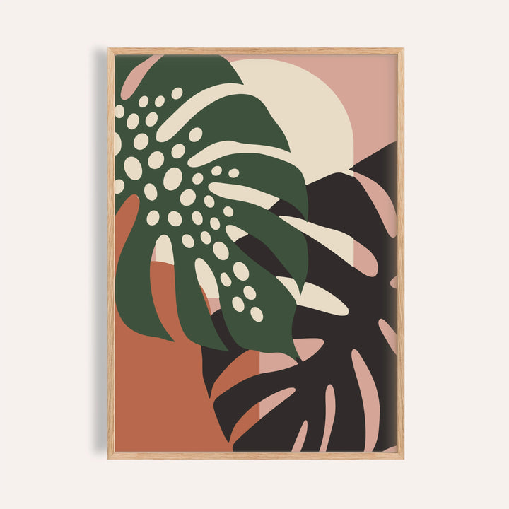 Tropical leaf print of two monstera leaves shown on a plain warm wall
