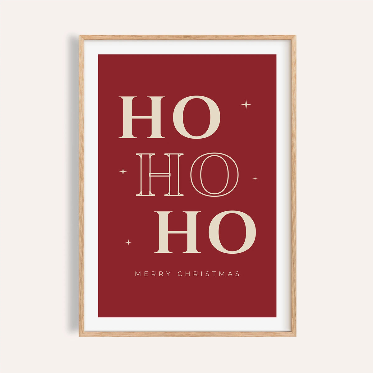 Red ho ho ho typography print shown on a plain warm wall