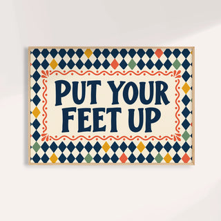 Relaxing wall art reading PUT YOUR FEET UP in navy on a harlequin pattern