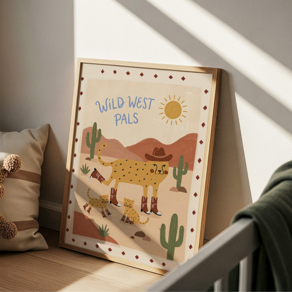 Playful nursery print showing cowboy cheetah in boots with two cubs and desert cacti