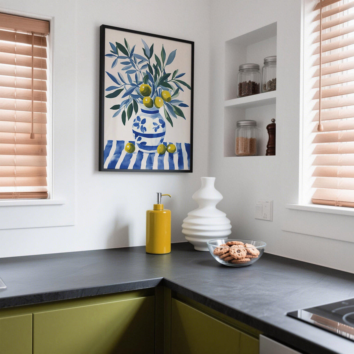 Still life olive tree wall art with a blue-and-white floral vase on striped fabric.