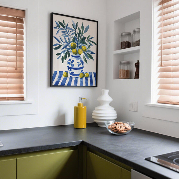 Still life olive tree wall art with a blue-and-white floral vase on striped fabric.