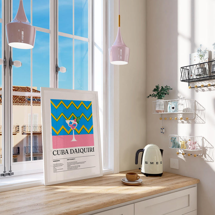 Print leaning on a kitchen counter with daiquiri cocktail artwork in blue pink and yellow
