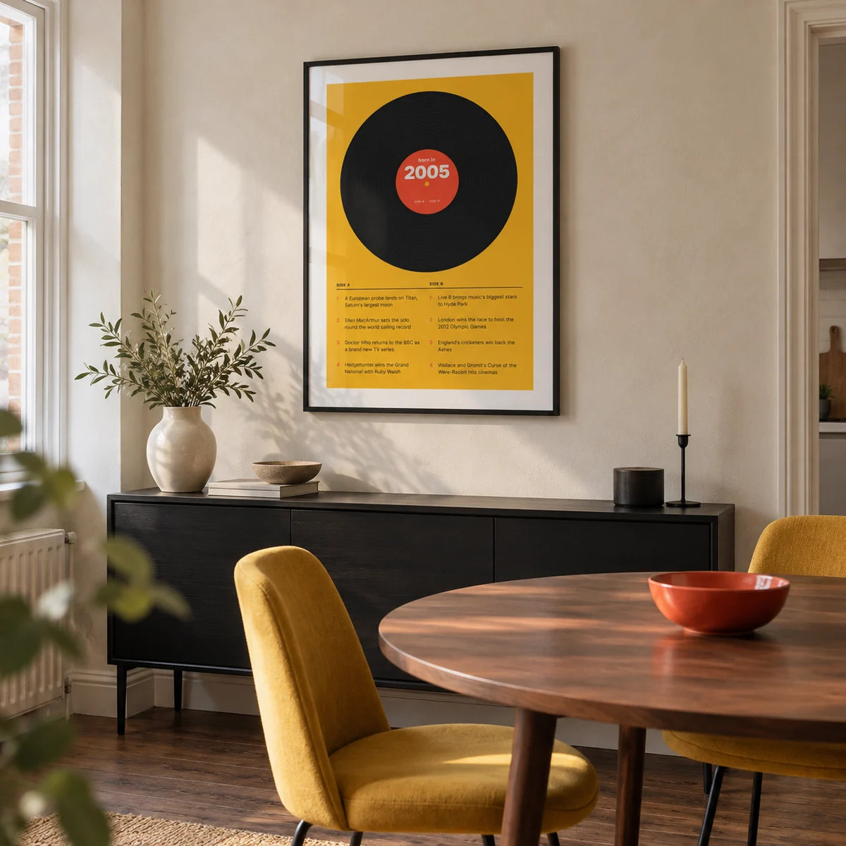 2005 Vinyl Record Print, framed on the wall of a modern dining nook in a small UK terraced home with a pale plaster wall and walnut floorboards