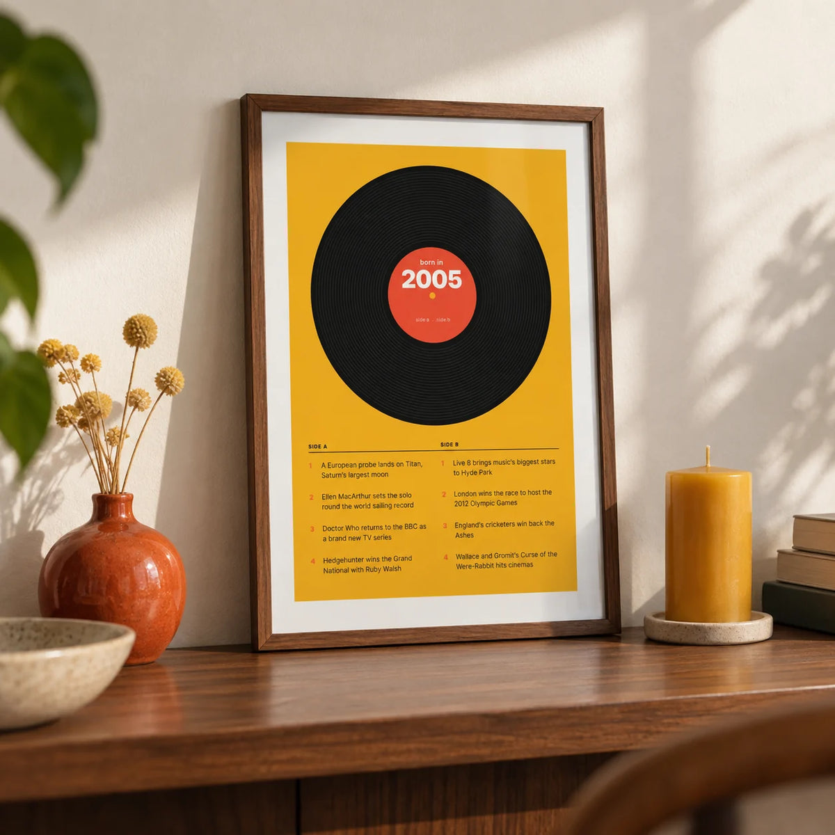2005 Vinyl Record Print, a small A4 framed print leaning on a walnut shelf in a living room