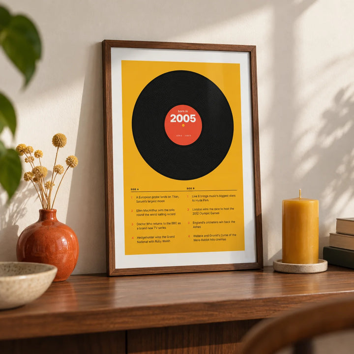 2005 Vinyl Record Print, a small A4 framed print leaning on a walnut shelf in a living room