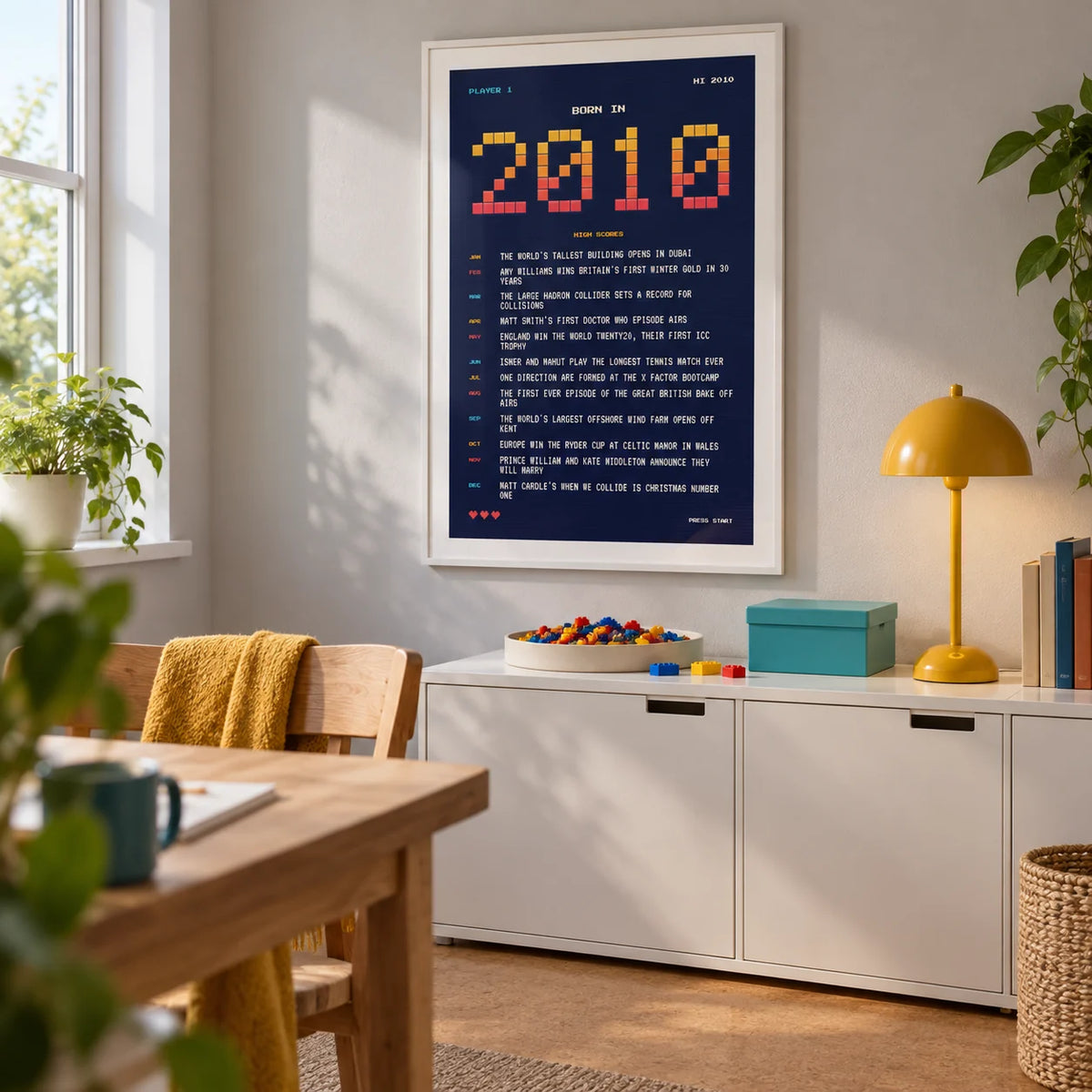 2010 Pixel Art Print, framed on the wall of a small creative hobby room in a British family house with a light grey wall and plain cork floor