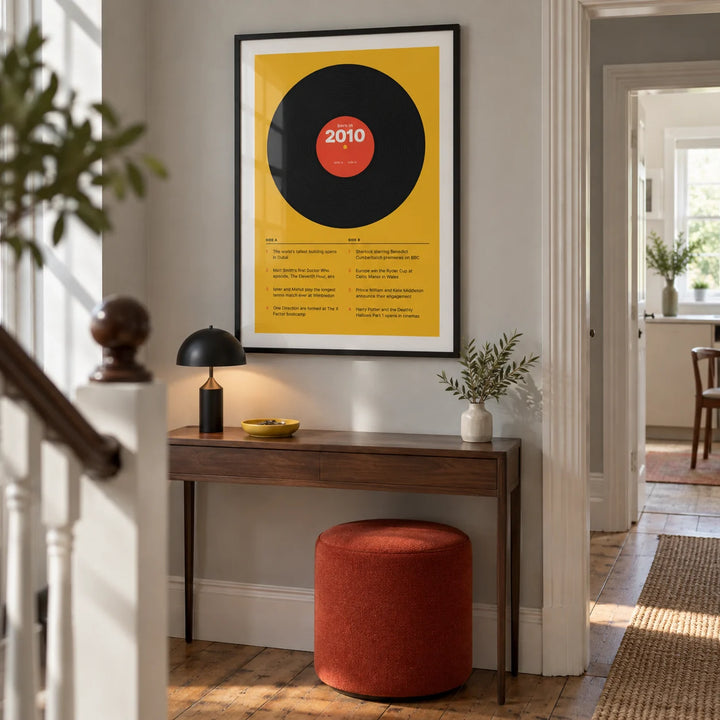 2010 Vinyl Record Print, framed on the wall of a crisp hallway in a renovated UK terrace with a pale grey wall and original timber floorboards